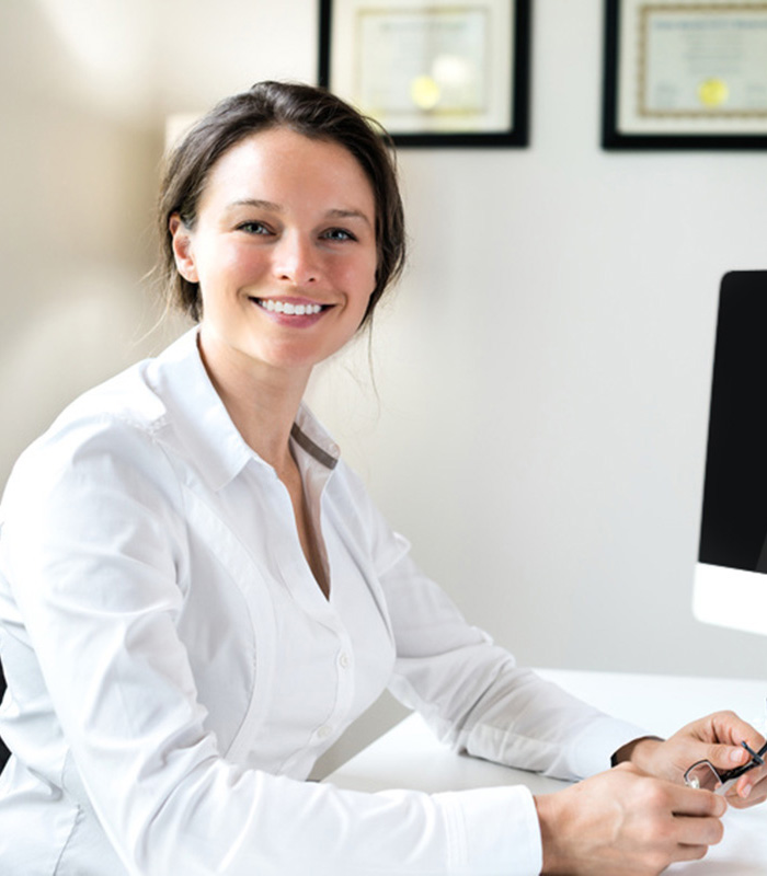 a doctor sitting at her desk at the facility